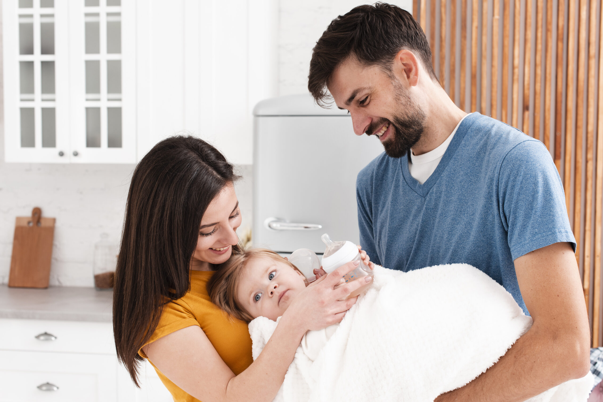 parents holding baby blanket scaled